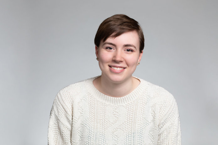 Gena Reynolds portrait in front of gray background.