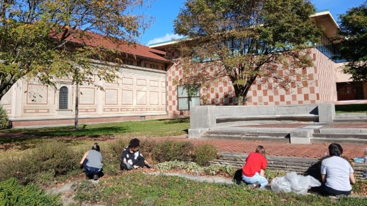 Students and staff weeding in front of the Venturi Art Building