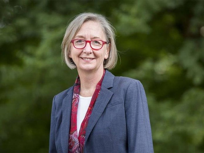 Valerie Hotchkiss portrait in front of greenery background.