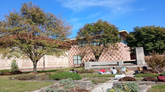 Students and staff weeding in front of the Venturi Art Building