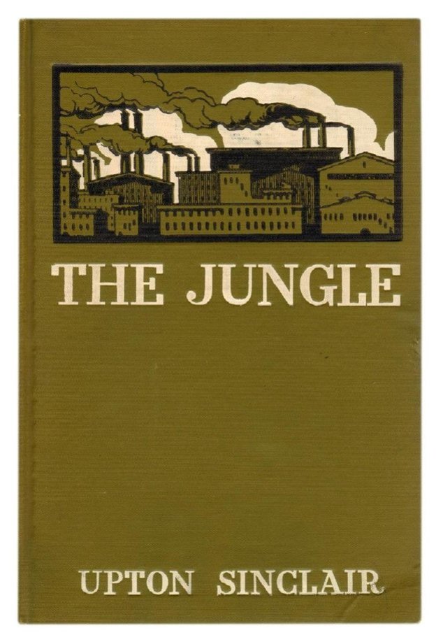 Green cover of The Jungle by Upton Sinclair, including an illustration of buildings, some of which have pipes expelling smoky material that is drifting through the air.